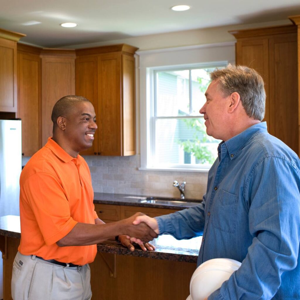 Two men shaking hands and talking